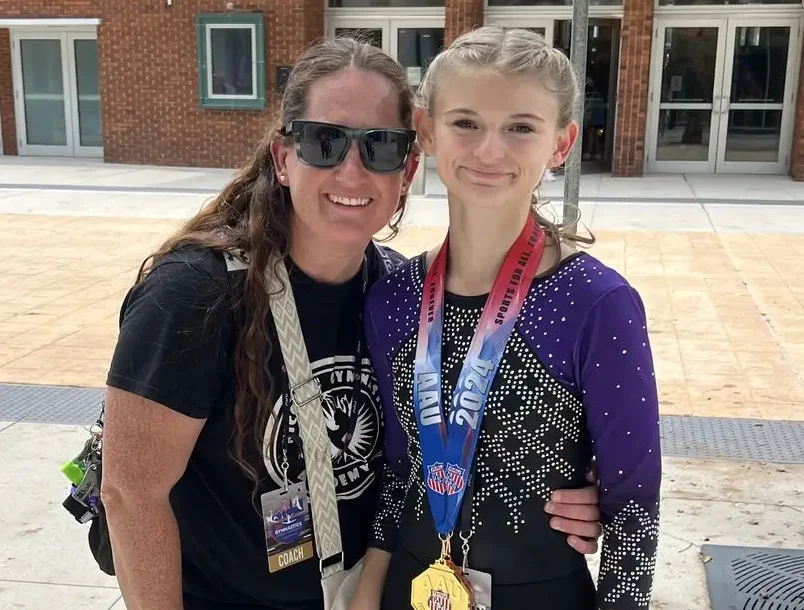 Nicole with a gymnast at competition
